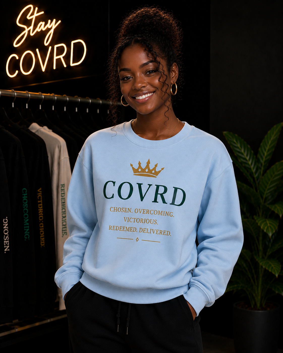 Person wearing a light blue sweatshirt with 'COVRD' text in a store setting.