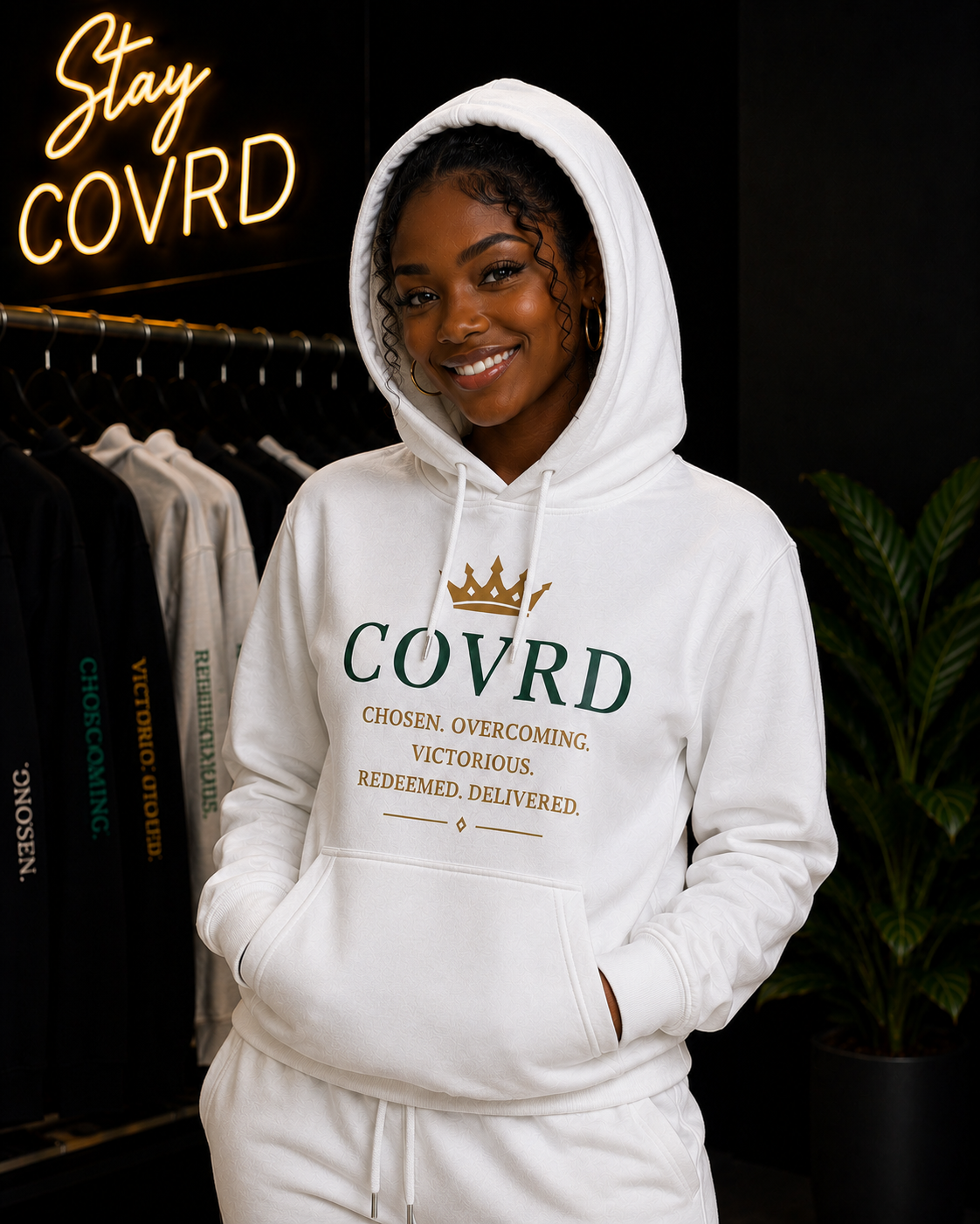 Person wearing a white hoodie with 'COVRD' branding in a store setting.