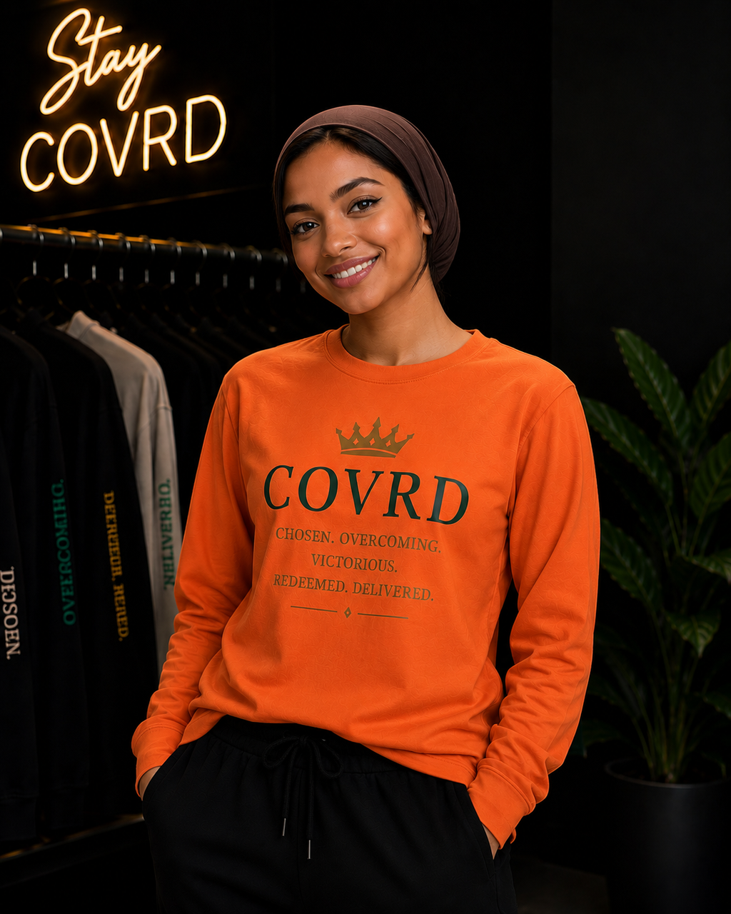 Person wearing an orange sweatshirt with 'COVRD' text in a store setting.